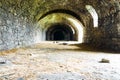 Corridor in the old part of the Old Kamianets-Podilskyi Castle with a view to ancient stone walls. Powder magazine of the old Royalty Free Stock Photo