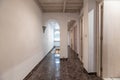 Corridor of residential house with white oak wooden doors, glossy dark stoneware floors Royalty Free Stock Photo
