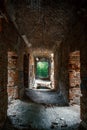 Corridor in ruined, abandoned ancient brick aged castle building