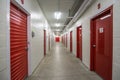 Corridor of self-storage unit with red doors Royalty Free Stock Photo