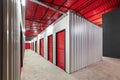 Corridor of self storage unit with red doors. Rental Storage Units Royalty Free Stock Photo