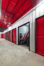 Corridor of self storage unit with red doors. Rental Storage Units Royalty Free Stock Photo