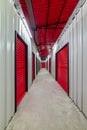 Corridor of self storage unit with red doors. Rental Storage Units Royalty Free Stock Photo