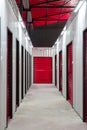 Corridor of self storage unit with red doors. Rental Storage Units Royalty Free Stock Photo