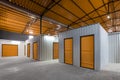 Corridor of self storage unit with red doors. Rental Storage Units Royalty Free Stock Photo