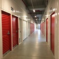 Corridor of self-storage unit with red doors Royalty Free Stock Photo
