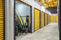 Corridor of self storage unit with yellow doors. Rental Storage Units Royalty Free Stock Photo