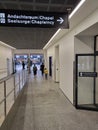 Corridor with signboard direction to multi faith praying space in Zurich airport.