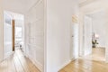 Corridor with white walls and beige parquet