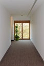 Corridor with wooden window at the end Royalty Free Stock Photo