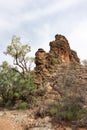 Corroboree rock: sacred Australian aboriginal rock, near Alice Springs. Vertical flat formation, orange colors. Vertical picture.