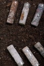 Corroded batteries covered with earth. Environmental protection and waste recycling. Close-up shot