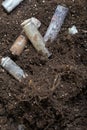 A corroded battery is lying on the ground. Environmental protection and waste recycling. Close-up shot