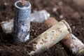 A corroded battery is lying on the ground. Environmental protection and waste recycling. Close-up shot