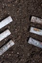 Corroded batteries covered with earth. Environmental protection and waste recycling. Close-up shot