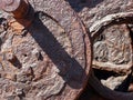 Corroded iron wheels covered in brown rust on old industrial machinery Royalty Free Stock Photo