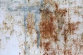 Corroded, painted white with spots of blue paint, old metal sheet. Background for your design.