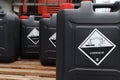 Corrosive chemical symbols on a black chemical tank