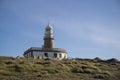 Corrubedo lighthouse, Galicia, Spain surrounded by the huge rocks Royalty Free Stock Photo