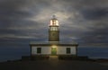 Corrubedo Lighthouse, Spain, illuminated at dusk Royalty Free Stock Photo