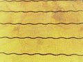 Corrugated canvas in modern golden yellow with violet wavy lines ideal for background, pattern, textile, website,paper,tapeta,abst Royalty Free Stock Photo