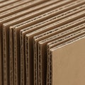 Corrugated cardboard sheets arranged in a vertical stack, showing the laye Royalty Free Stock Photo