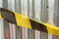 corrugated gray zinc with yellow and black forbidden lines