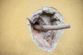 Corrugated hose sticking out of a hole in the wall