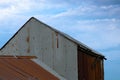 Corrugated iron farm building with red roof