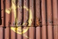 Corrugated iron painted red yellow circle rust places