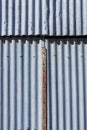 Corrugated iron texture with a rusted metal strip in the middle