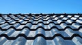 A corrugated metal roof against a clear blue sky, showcasing its texture and pattern. Royalty Free Stock Photo