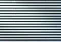 Corrugated metal sheet. Silver gray background pattern with shiny reflection. Royalty Free Stock Photo