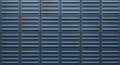 Corrugated metal wall composed of evenly arranged blue panels, each featuring Royalty Free Stock Photo