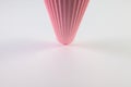 Corrugated pink paper roll on the white desk. Royalty Free Stock Photo