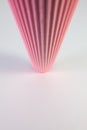 Corrugated pink paper roll on the white desk. Royalty Free Stock Photo
