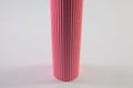 Corrugated pink paper roll on the white desk. Royalty Free Stock Photo