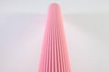 Corrugated pink paper roll on the white desk. Royalty Free Stock Photo