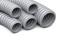 Corrugated pipe for installation of electrical cable. Grey plastic curvilinear hoses set.