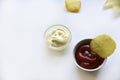 Corrugated potato chips with pepper on a white background. Delicious fast food chips. with sauce