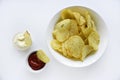 Corrugated potato chips with pepper on a white background. Delicious fast food chips. with sauce
