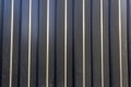 Corrugated sheet metal, badly painted with gray paint for background. Metal corrugated roofing sheet.