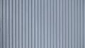 Corrugated sheet metal, badly painted with gray paint for background. Metal corrugated roofing sheet. Abstract background for