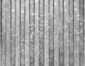 Corrugated vertical sheet aluminum facade. Grunge grainy metal texture. Silver color industrial pattern. Garage construction gray