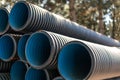 Corrugated water pipes of large diameter prepared for laying, copy space Royalty Free Stock Photo