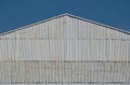 Corrugated zinc facade soars into blue sky Royalty Free Stock Photo