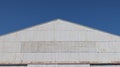 Corrugated zinc facade soars into blue sky Royalty Free Stock Photo