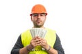 Corrupted builder man in handcuffs holding stolen money Royalty Free Stock Photo