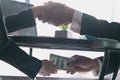 Corrupted businessman sealing the deal with a handshake and receiving a bribe money, anti bribery and corruption concepts Royalty Free Stock Photo