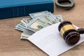 Dollars in an envelope, handcuffs, gavel and book judge. Royalty Free Stock Photo